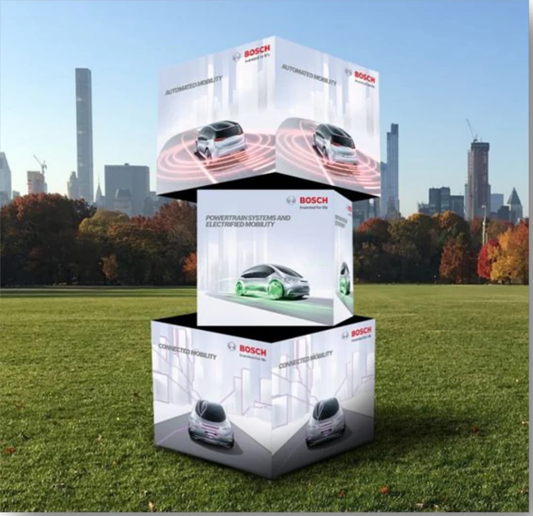 The same display cubes in white, showing Bosch vehicles and technology