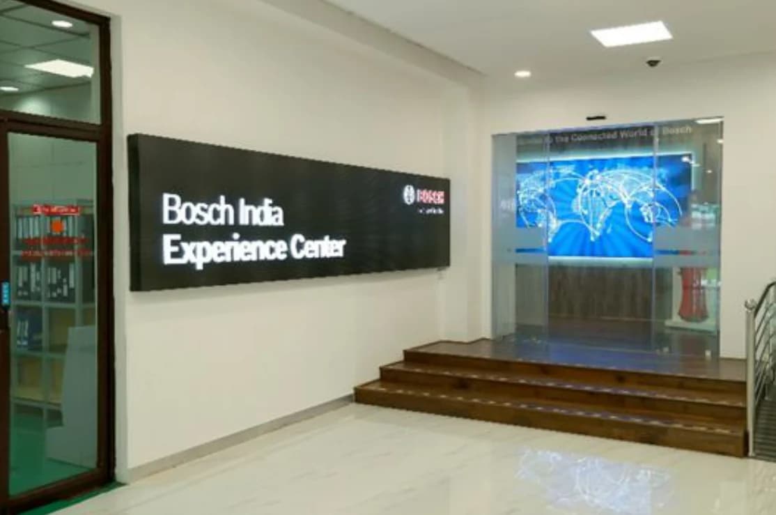 The Bosch India Experience Center entrance: a black name wall and a glowing world map
