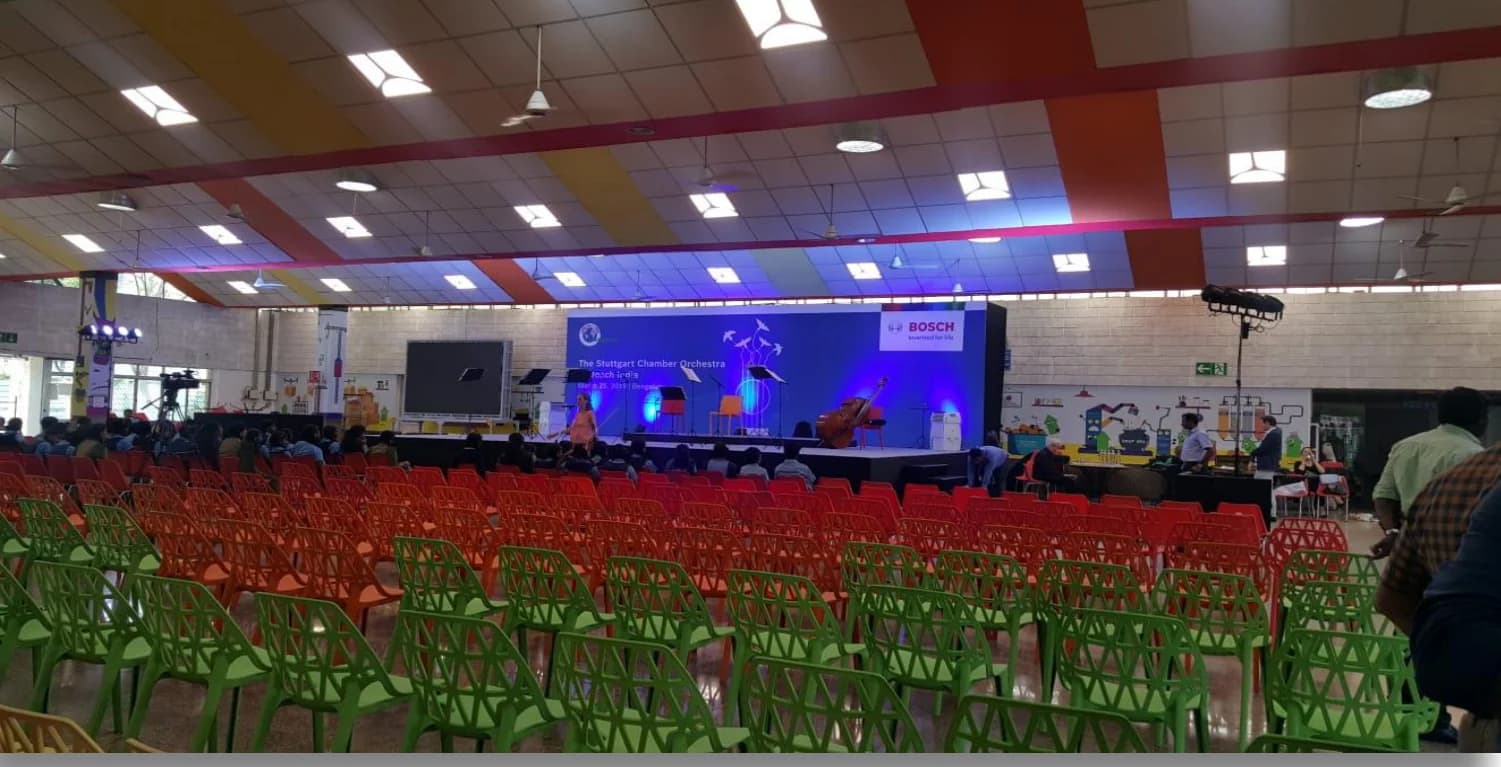 The hall set for the concert, red seating facing the stage