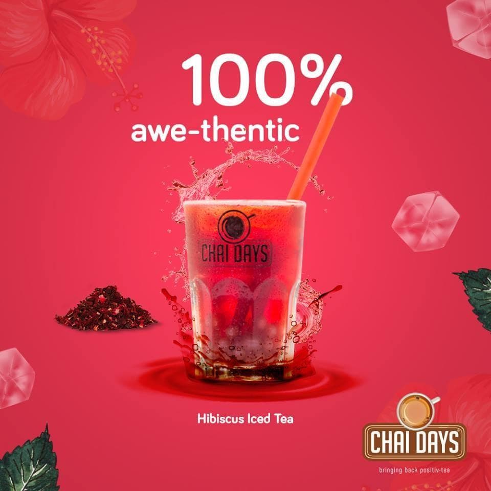 Red creative with a splashing glass of hibiscus iced tea, dried hibiscus and ice cubes, with the text “100% awe-thentic” and “Hibiscus Iced Tea”