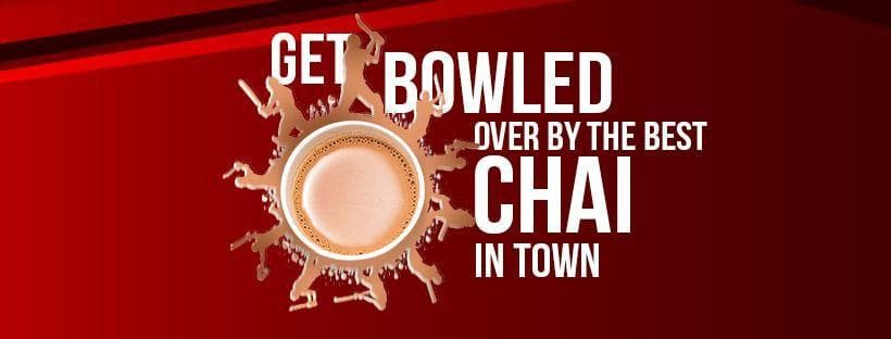 Red banner with a cup of chai ringed by splash silhouettes of cricketers and the line “Get bowled over by the best chai in town”