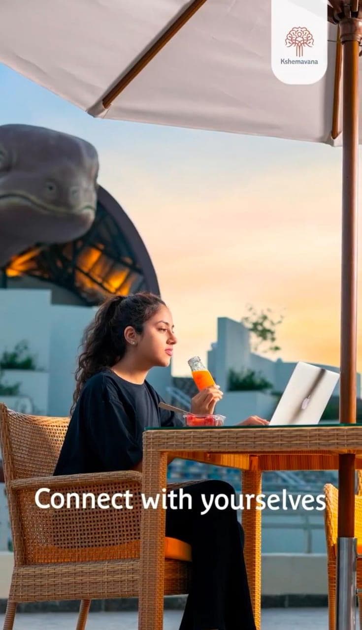 Lifestyle video still: a woman working at a terrace table, captioned Connect with yourselves