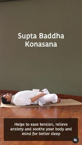Yoga video still: Supta Baddha Konasana demonstrated on a mat